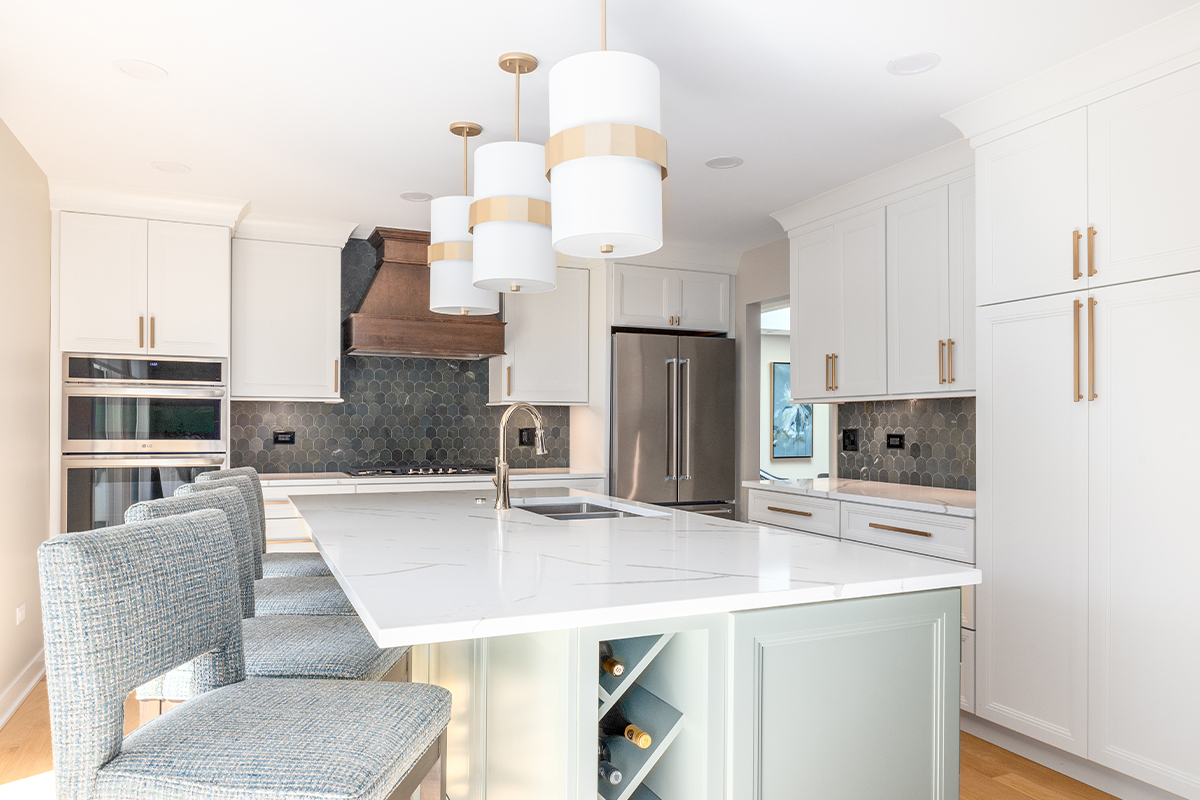 White painted kitchen perimeter with stained wood hood and gray painted island
