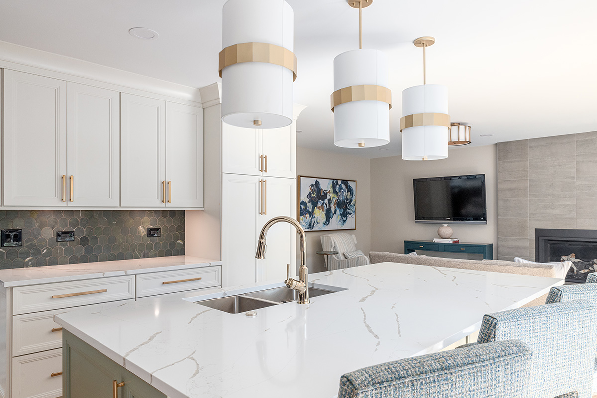 White painted kitchen perimeter with stained wood hood and gray painted island