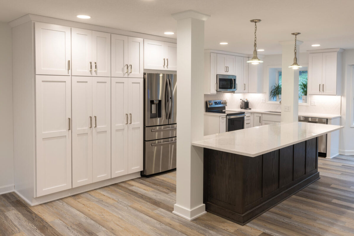 kitchen with white painted perimeter cabinets and reddish brown stained island