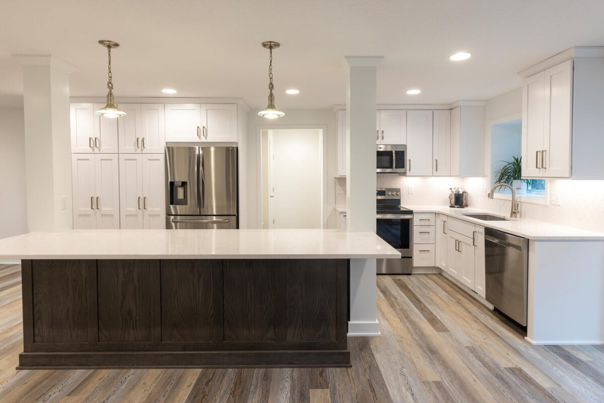 kitchen with white painted perimeter cabinets and reddish brown stained island