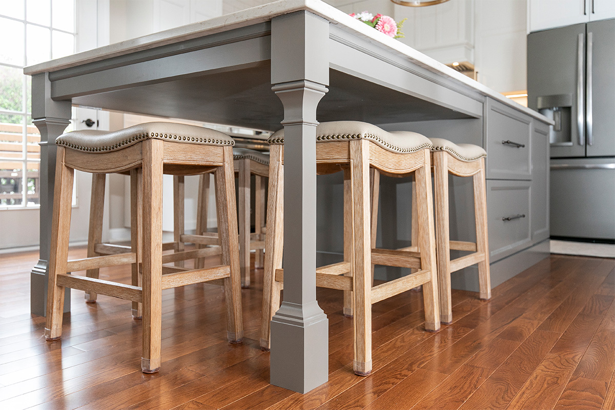 Gray painted island with decorative legs