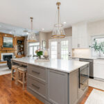 Painted kitchen cabinets. White perimeter and gray island.