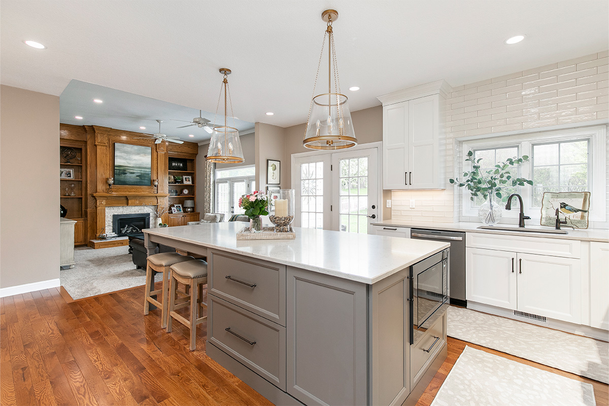 Painted kitchen cabinets. White perimeter and gray island.