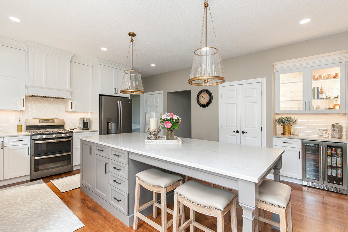 Painted kitchen cabinets. White perimeter and gray island.