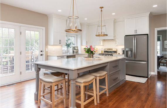 Painted kitchen cabinets. White perimeter and gray island.