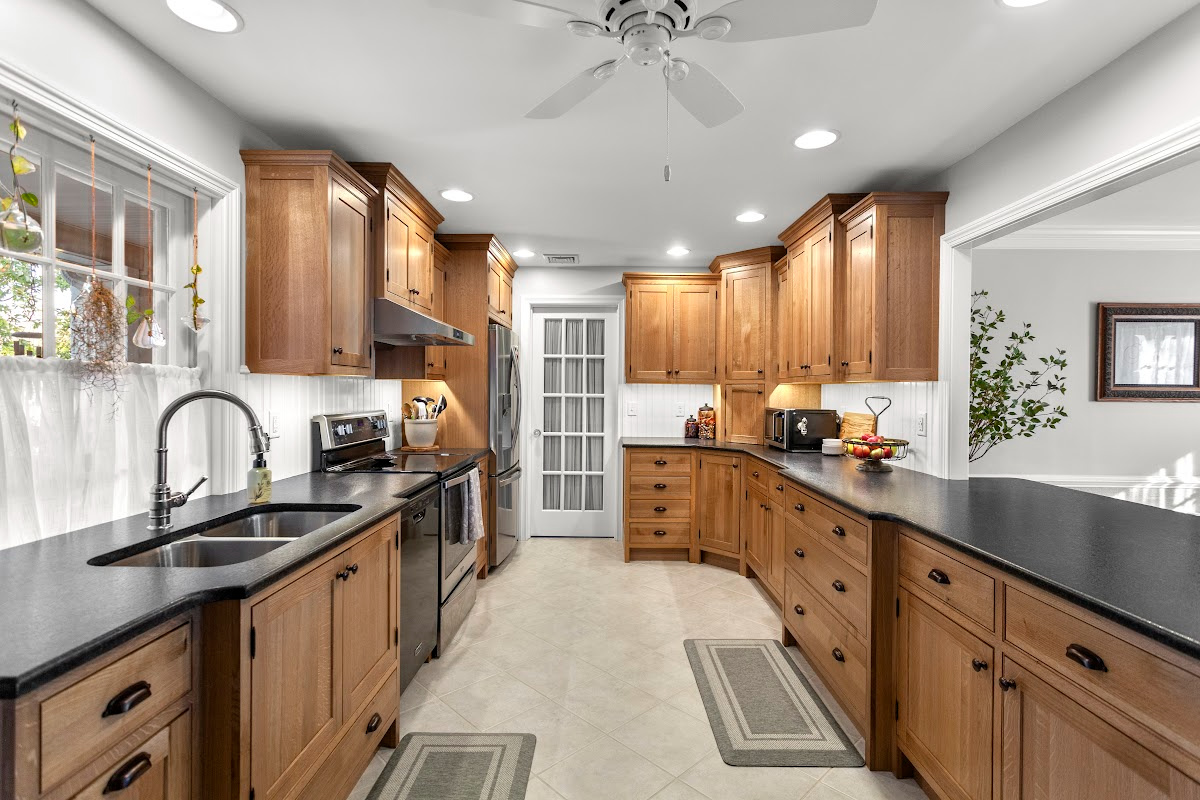 Stained cabinets in a narrow kitchen. Cabinets made with quartersawn white oak stained with Buff finish.