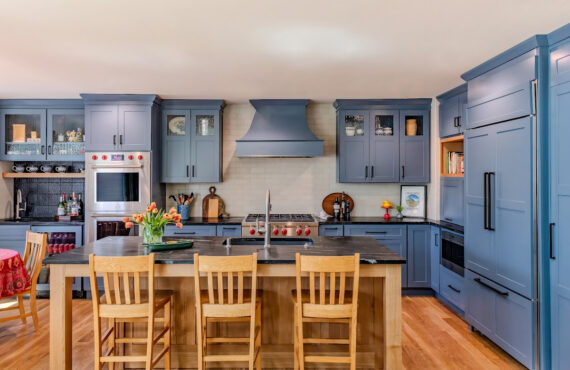 Blue painted kitchen cabinets with stained island.