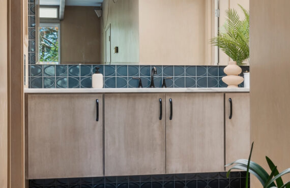 Retro bathroom with slab door floating vanity finished with the earthy Montana stain on Maple.