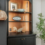 Open shelf bookcase next to a fireplace