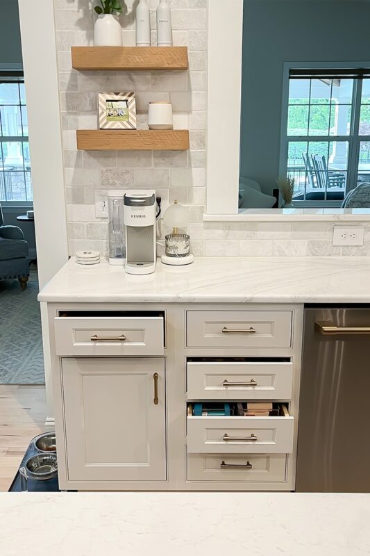 Coffee area in a kitchen with stained floating shelves
