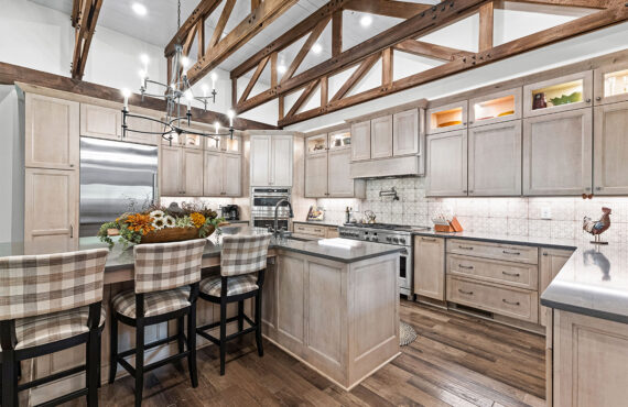 Light stained kitchen cabinets with exposed beams