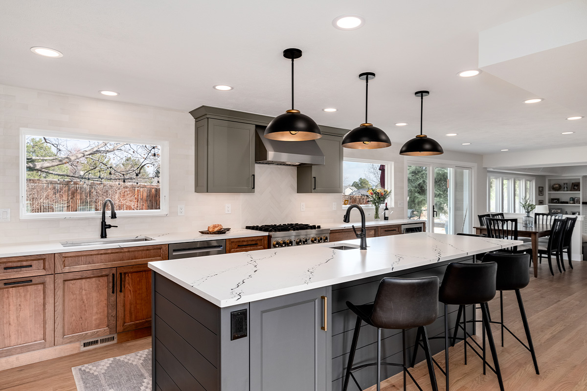 Painted gray and stained brown kitchen cabinets.