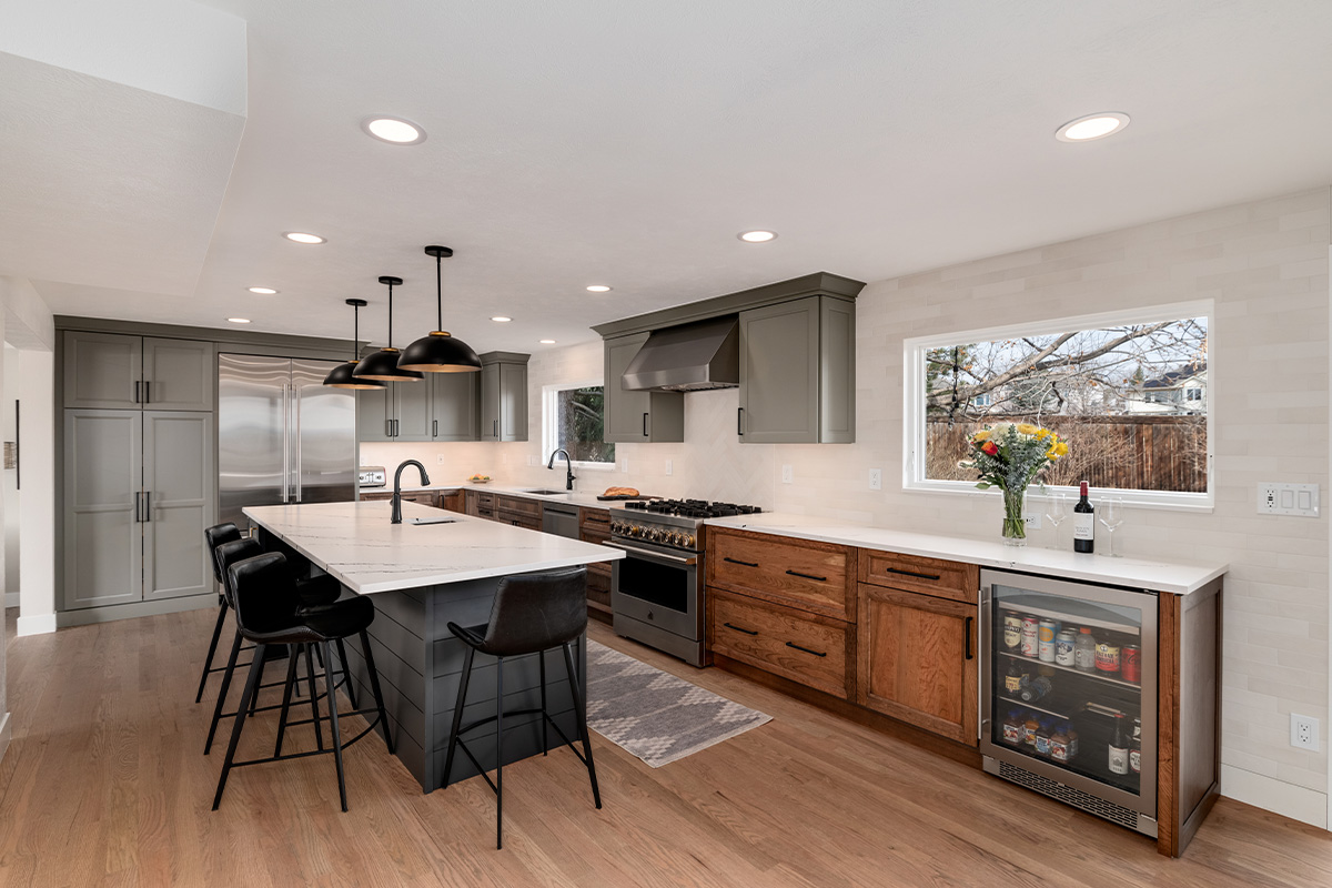Painted gray and stained brown kitchen cabinets.