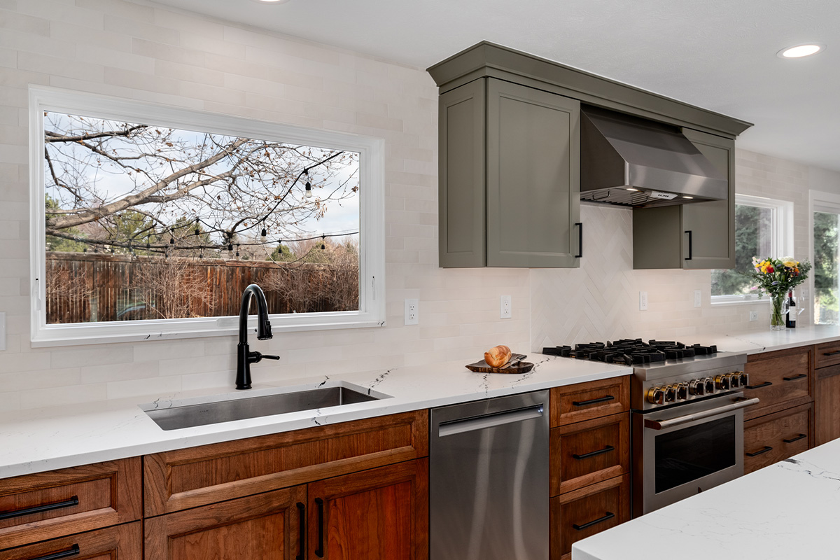 Painted gray and stained brown kitchen cabinets.