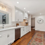 White painted kitchen with wood floors