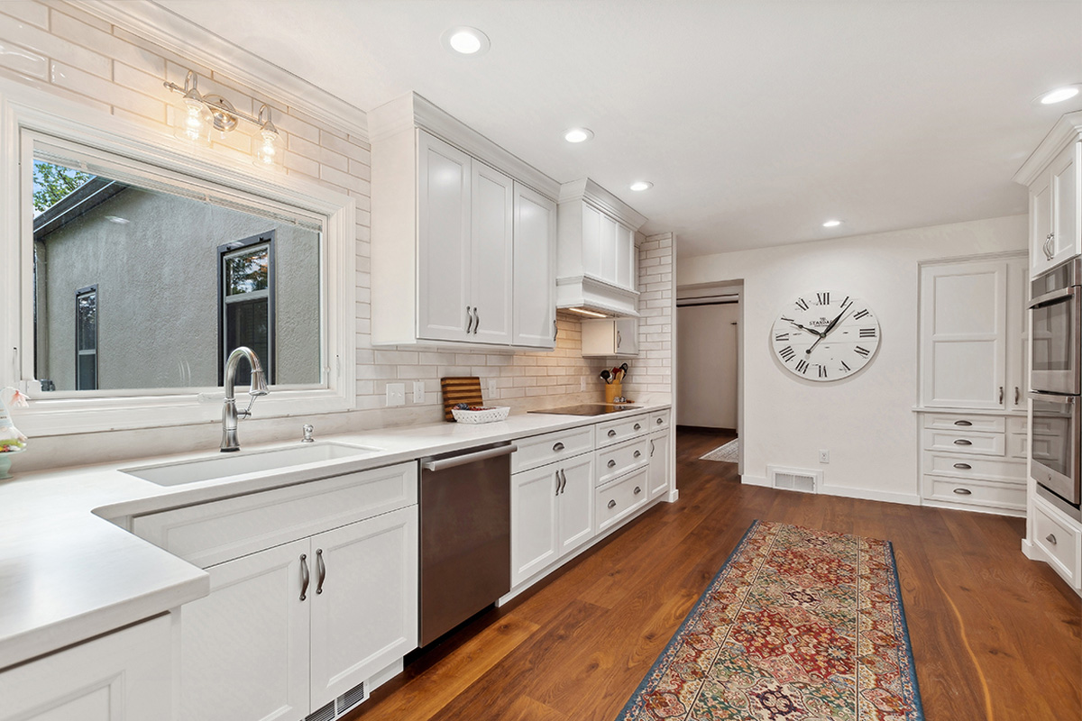 White painted kitchen with wood floors