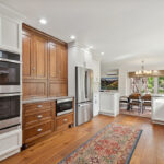 White kitchen with brown stained accent cabinets