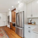 White kitchen with brown stained accent cabinets