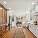 White kitchen with brown stained accent cabinets