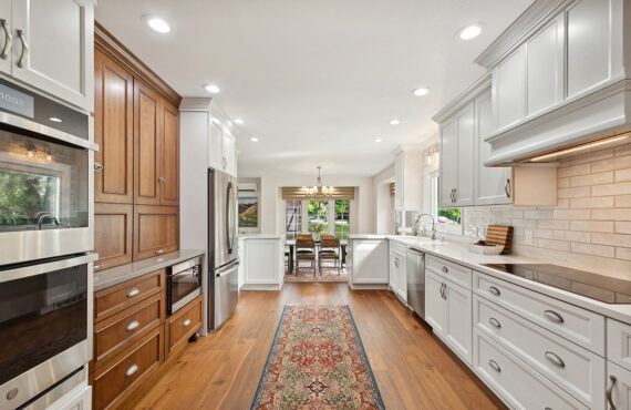 White kitchen with brown stained accent cabinets