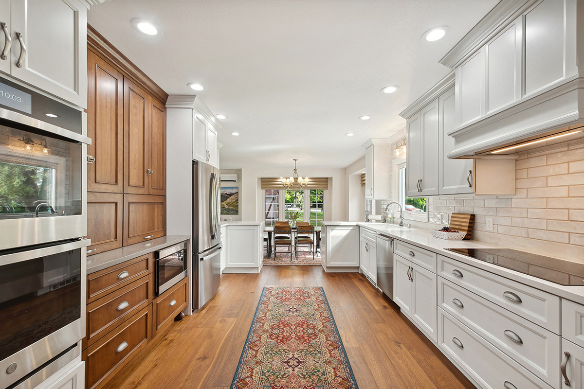 White kitchen with brown stained accent cabinets