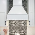 Painted white wood range hood with decorative backsplash