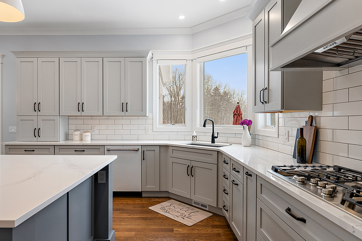 Painted gray kitchen cabinets and island.