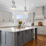 Painted gray kitchen cabinets and island.