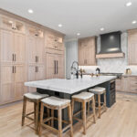 Light stained perimeter kitchen cabinets and Graphite painted island and hood.