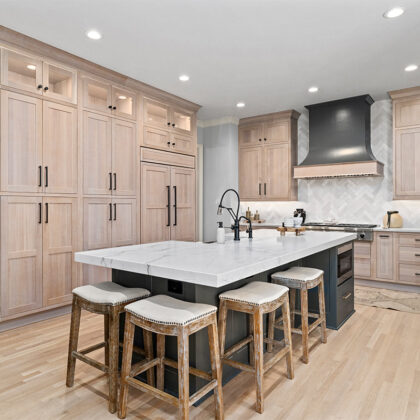 Light stained perimeter kitchen cabinets and Graphite painted island and hood.