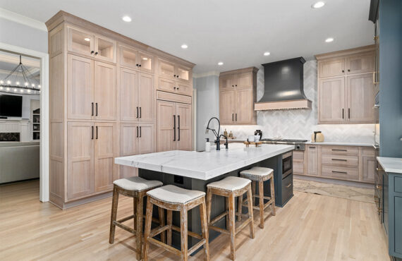 Light stained perimeter kitchen cabinets and Graphite painted island and hood.