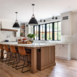 White painted perimeter and light brown stained island cabinets.