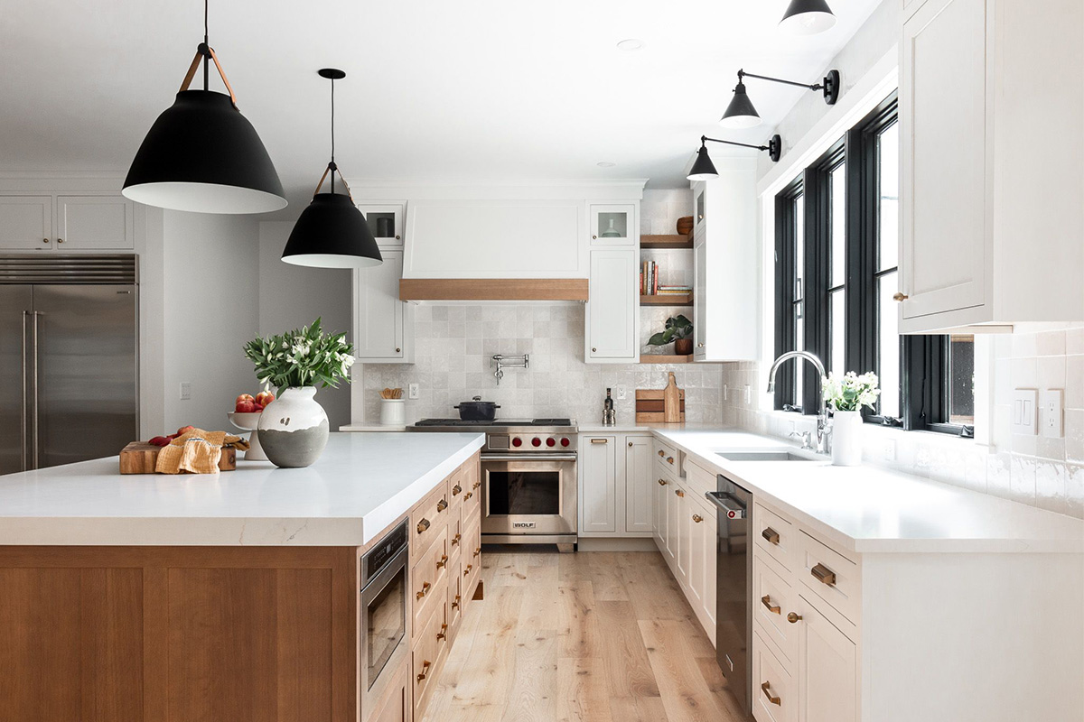White painted perimeter and light brown stained island cabinets.