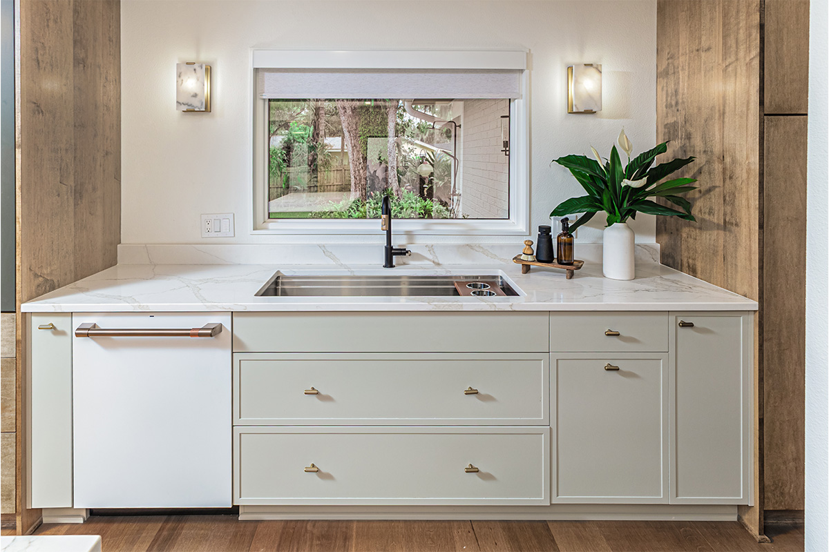Oyster painted kitchen cabinets with sink and window looking outside