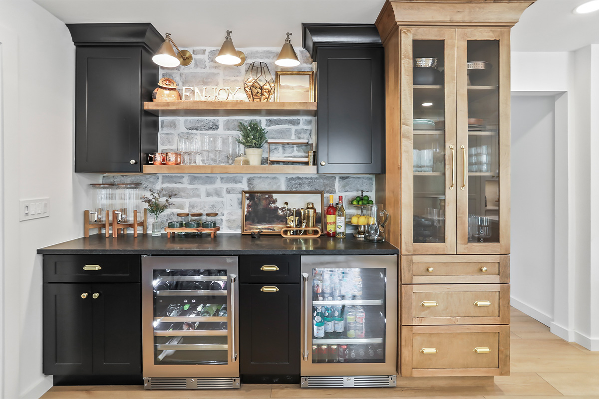 Dining room with black bar cabinets and light brown stained cabinet beside the bar.