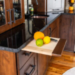 Cutting board extended out with lemon and a knife.