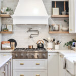 White kitchen with light brown stained island.