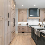 Light stained perimeter kitchen cabinets and Graphite painted island and hood.