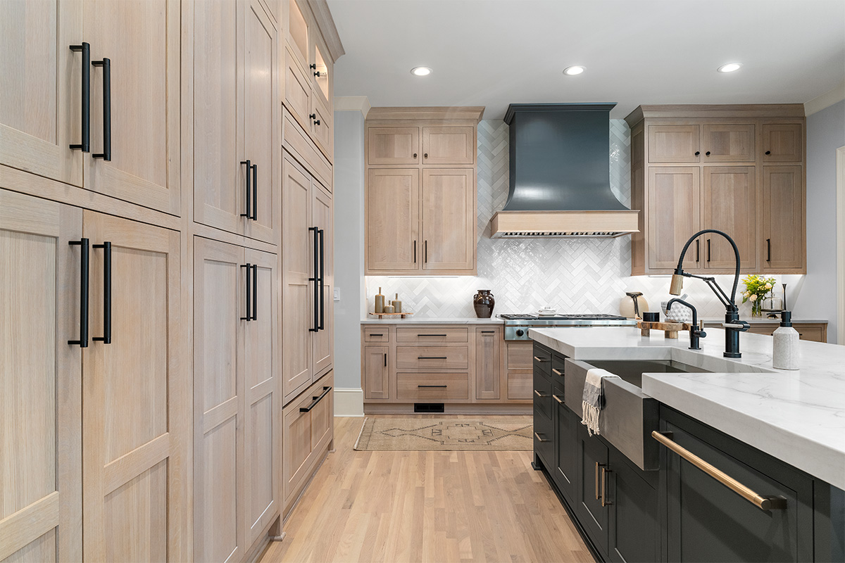 Light stained perimeter kitchen cabinets and Graphite painted island and hood.