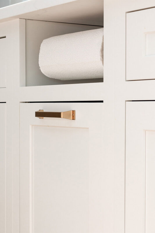 White painted kitchen cabinet with paper towel holder accessory