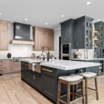 Light stained perimeter kitchen cabinets and Graphite painted island and hood.