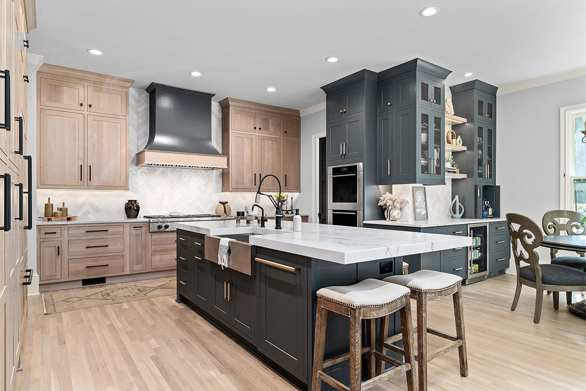 Light stained perimeter kitchen cabinets and Graphite painted island and hood.