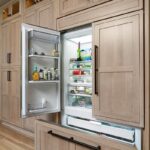 Light stained perimeter kitchen cabinets.