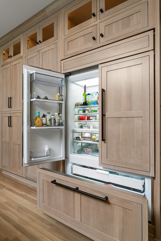 Light stained perimeter kitchen cabinets.