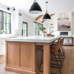 White painted perimeter and light brown stained island cabinets.
