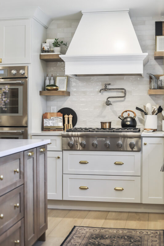 White kitchen with light brown stained island.