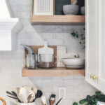 White cabinets with stained floating shelves