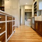 Kitchen island cabinets with painted frame and walnut natural drawer fronts and doors.
