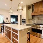 Painted cream and green kitchen cabinets.
