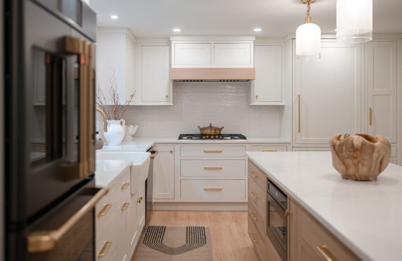 Kitchen with White perimeter cabinets and Quartersawn White Oak island cabinets stained in light brown Pampas finish.